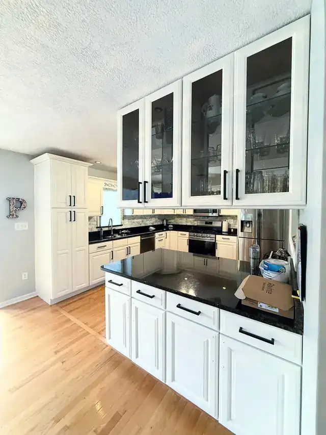 White kitchen cabinetry with glass-front upper doors