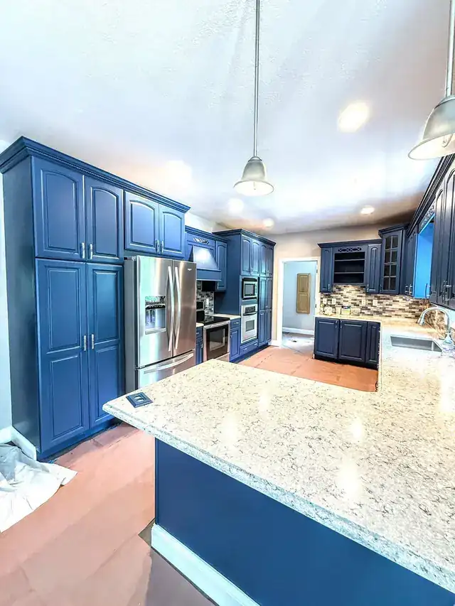 Navy painted kitchen cabinets under granite