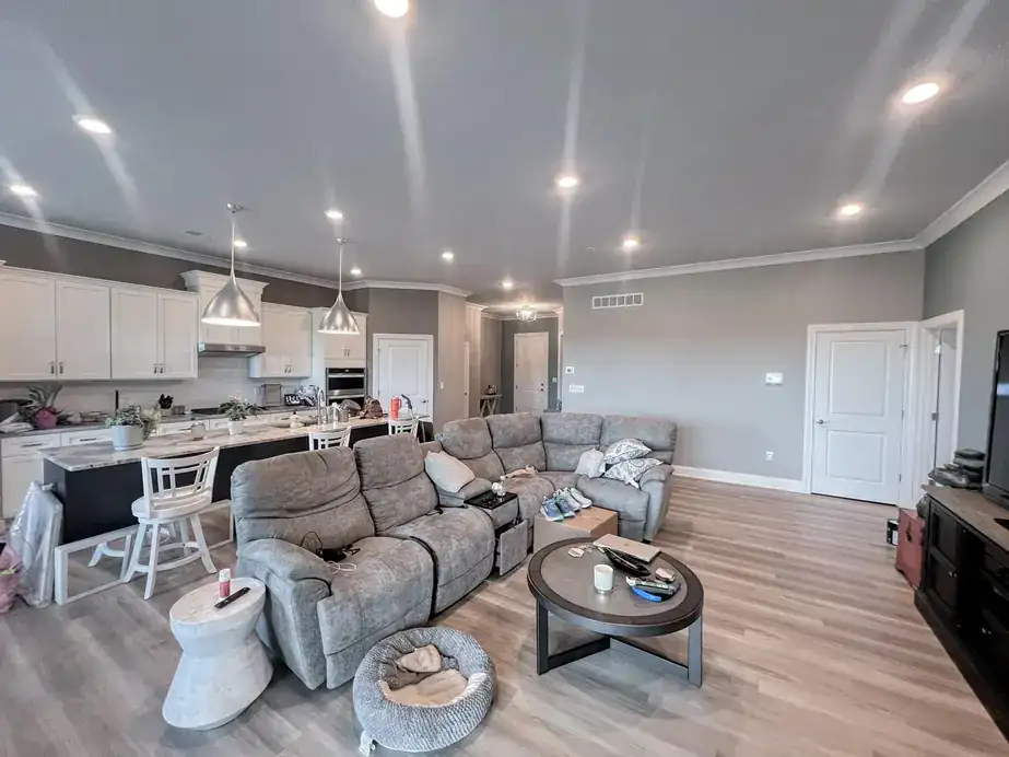 Open kitchen and great room freshly painted in warm grey