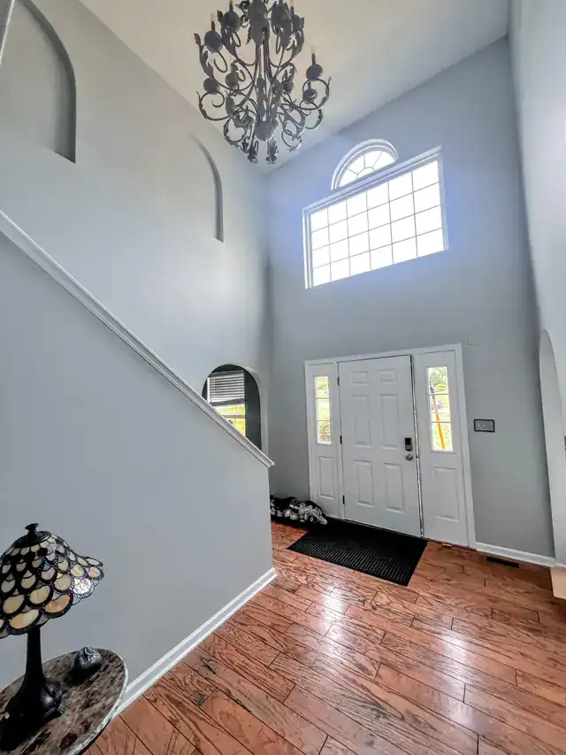Two-storey foyer with grey walls and a high window