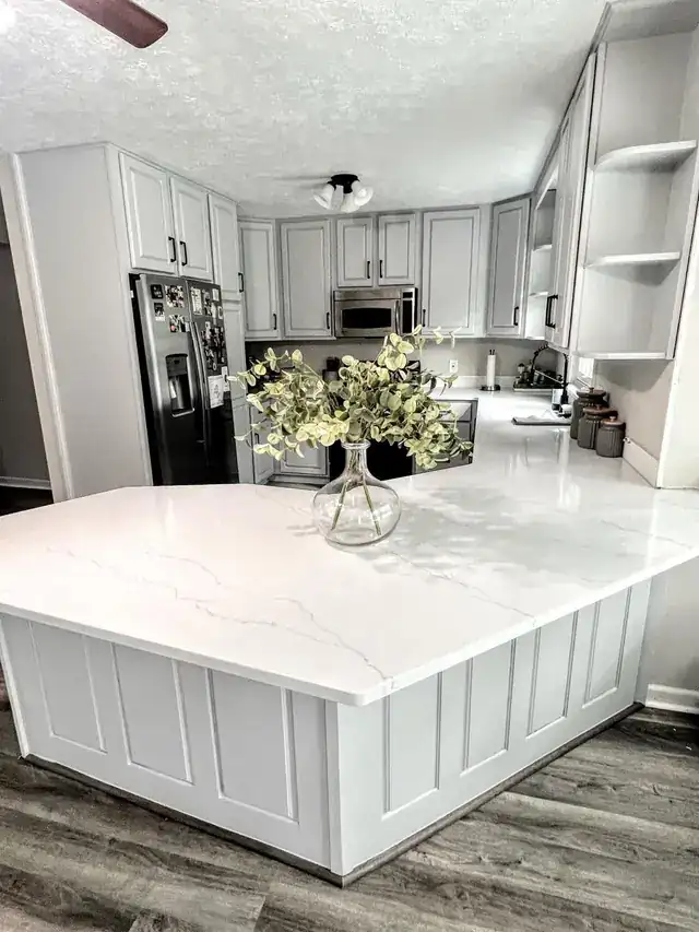 White kitchen island with a quartz top