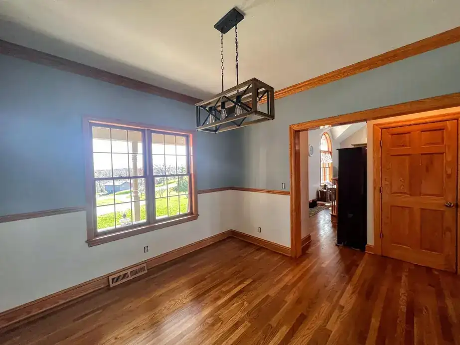Dining room with two-tone walls divided by a chair rail