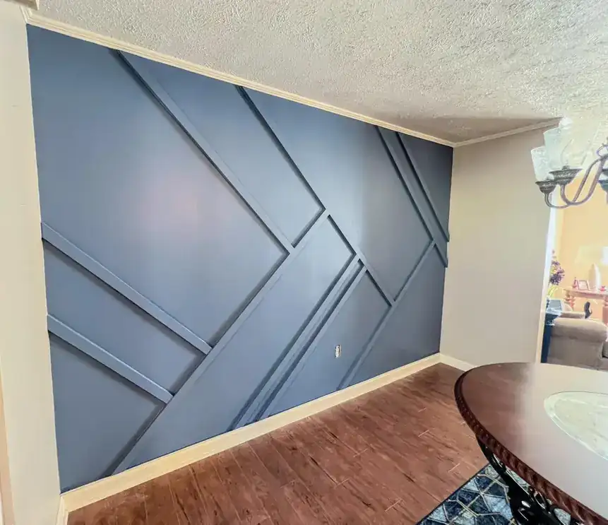 Living room accent wall with geometric trim painted blue-grey