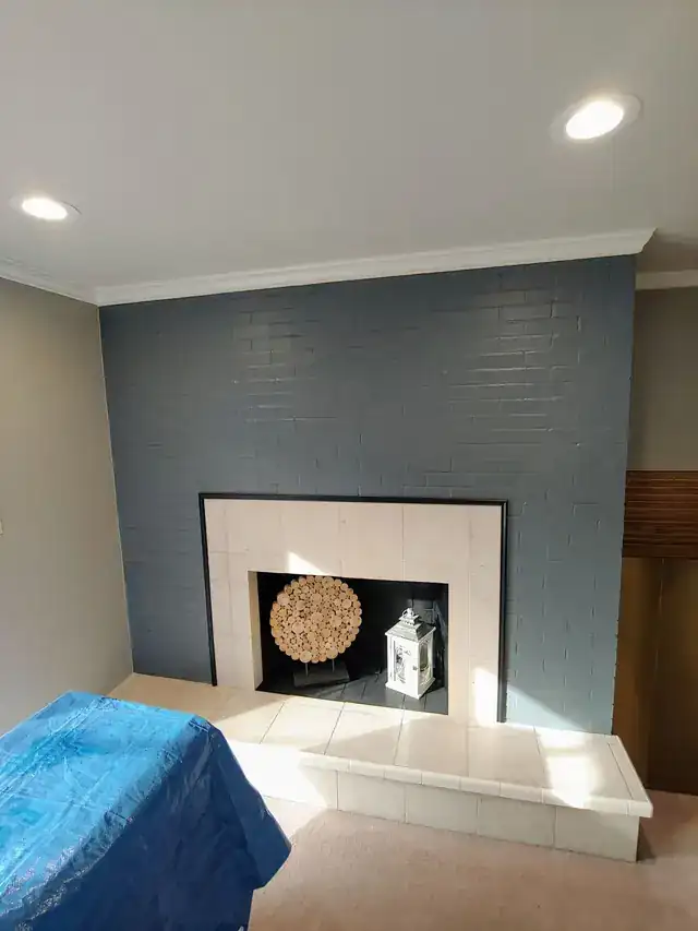 Brick fireplace wall painted slate grey