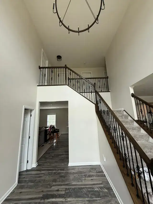 Two-storey stairwell with iron balusters
